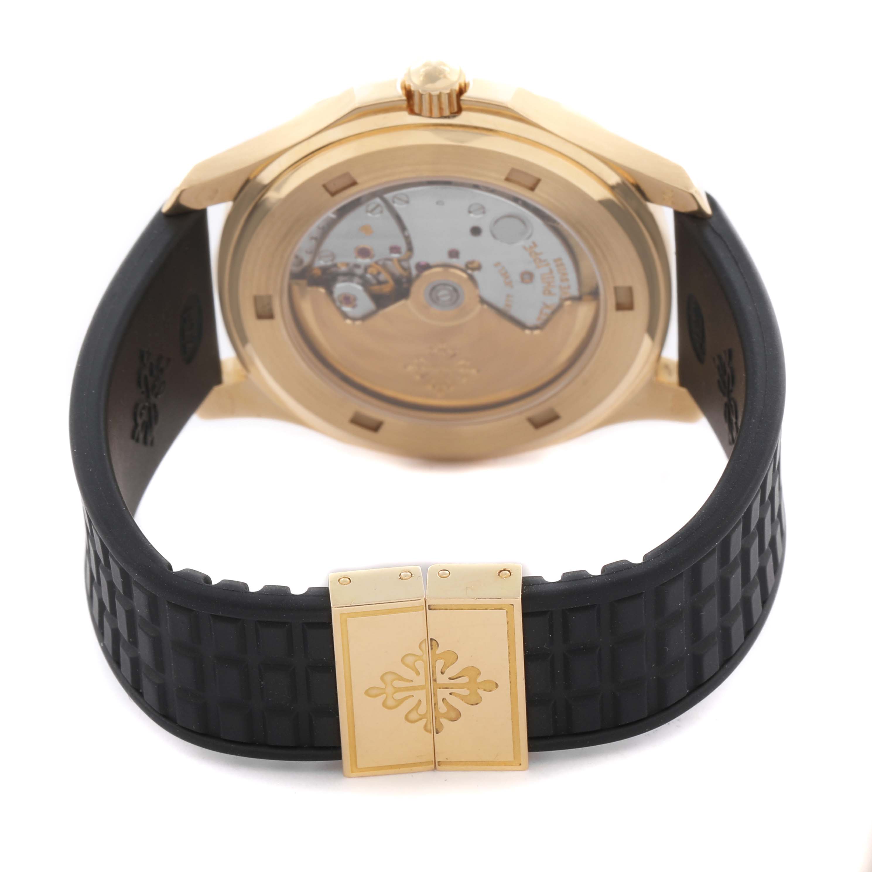 The Patek Philippe Aquanaut 5065J Men's Yellow Gold Black Dial 5065J Men's Yellow Gold Black Dial is shown from the back, highlighting its transparent case back and black strap with a clasp.