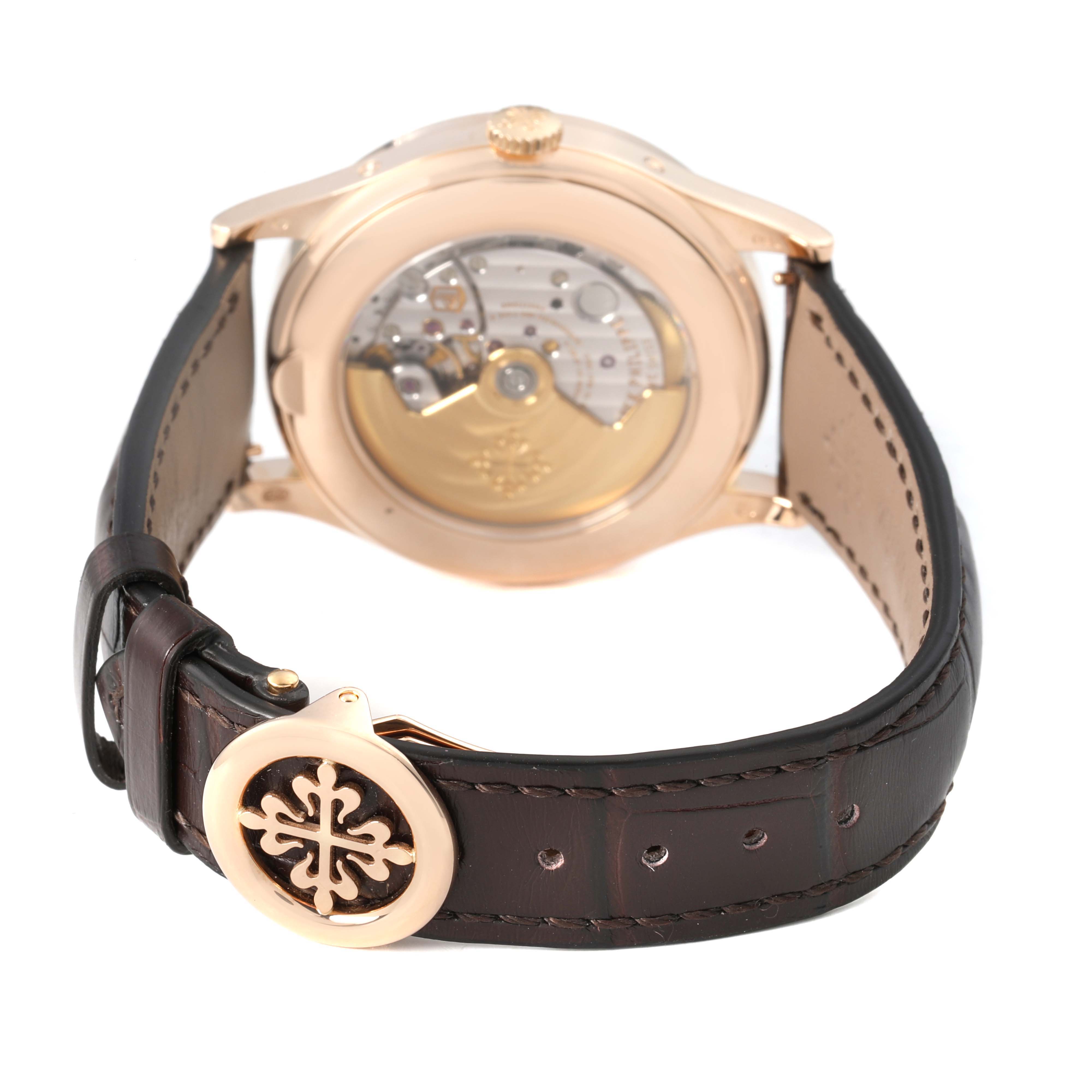 The image shows the back of a Patek Philippe Complications 5396R-001 Men's Rose Gold Silver Dial watch, highlighting the movement and strap detail with clasp.