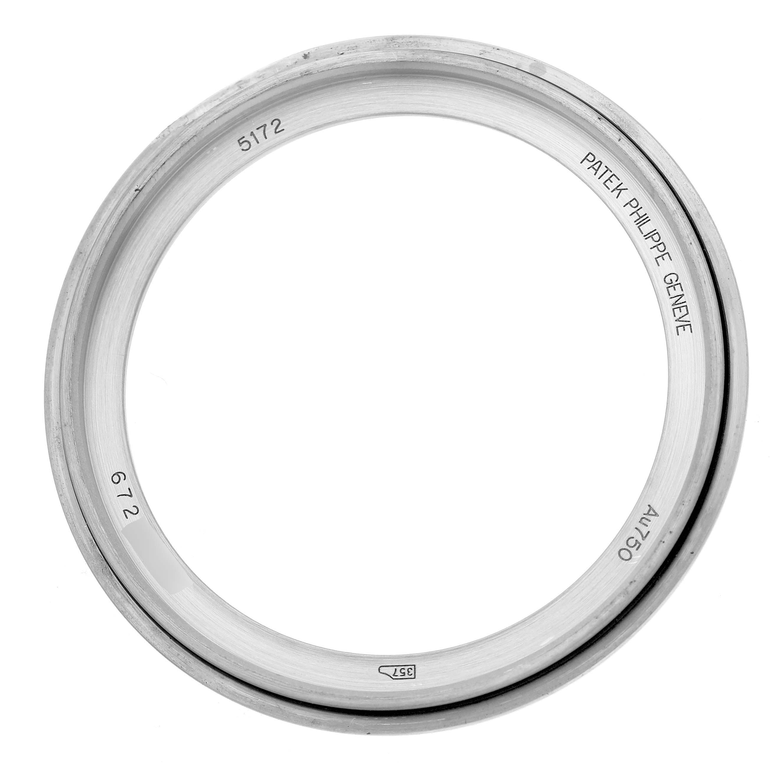 The image shows a close-up of the bezel of a Patek Philippe Complications 5172G-001 Men's White Gold Pink Dial watch, with model numbers engraved.