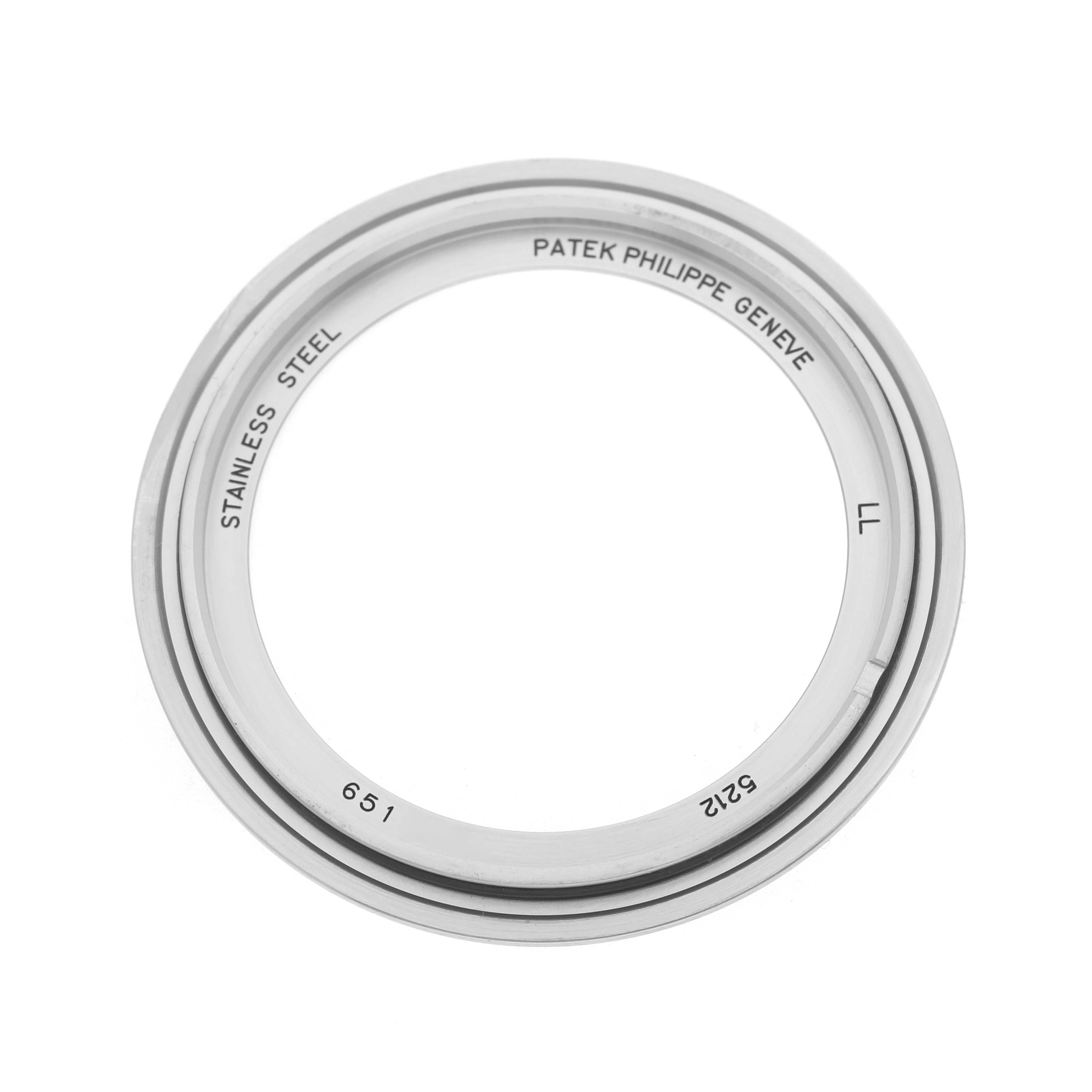 The image shows a stainless steel bezel for a Patek Philippe Complications 5212A-001 Men's Stainless Steel Silver Dial watch, seen from a top-down angle.