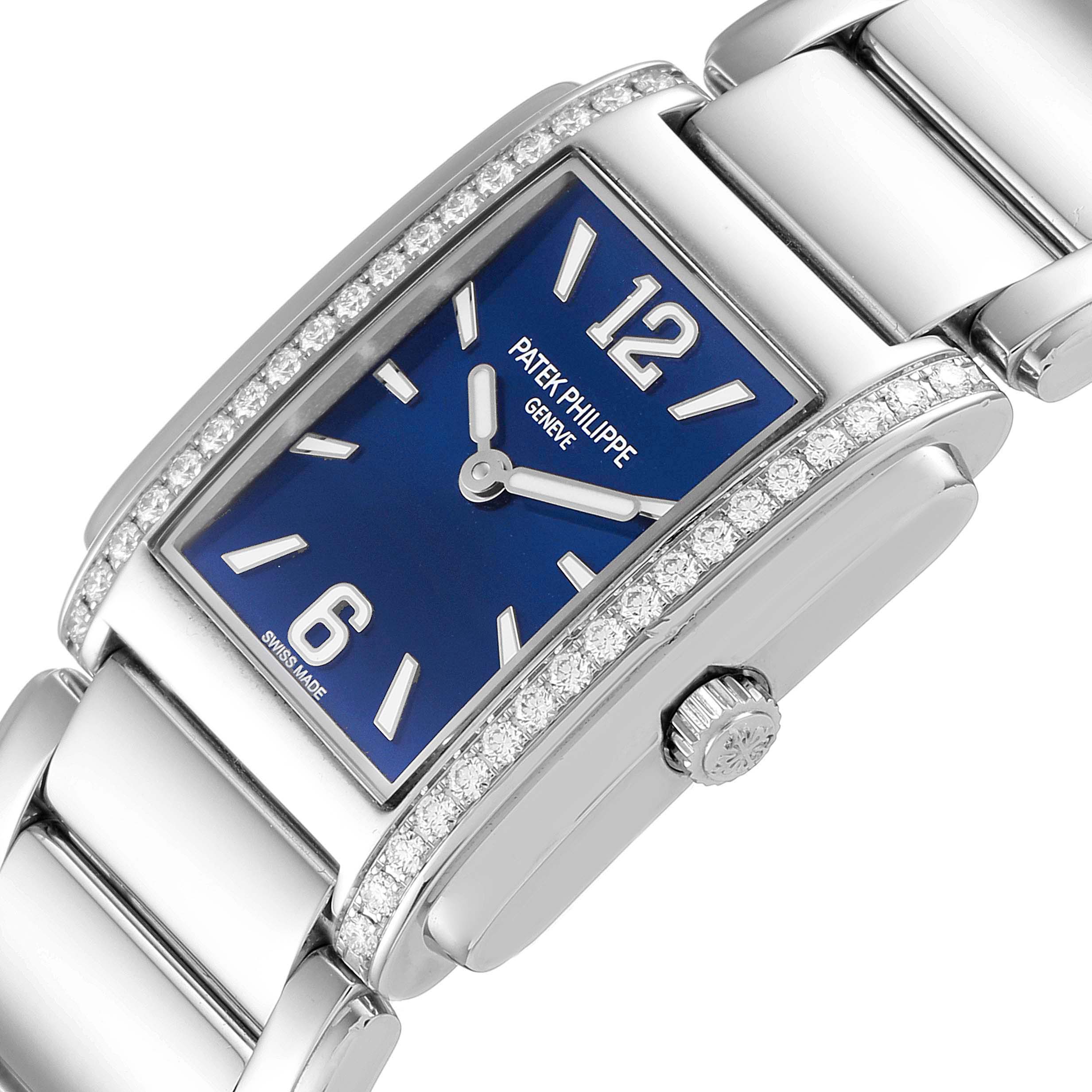 The image displays a Patek Philippe Twenty-4 4910/1200A Women's Stainless Steel Blue Dial 4910/1200A Women's Stainless Steel Blue Dial watch from an angled side view, showing the blue dial, diamond-set bezel, and part of the bracelet.