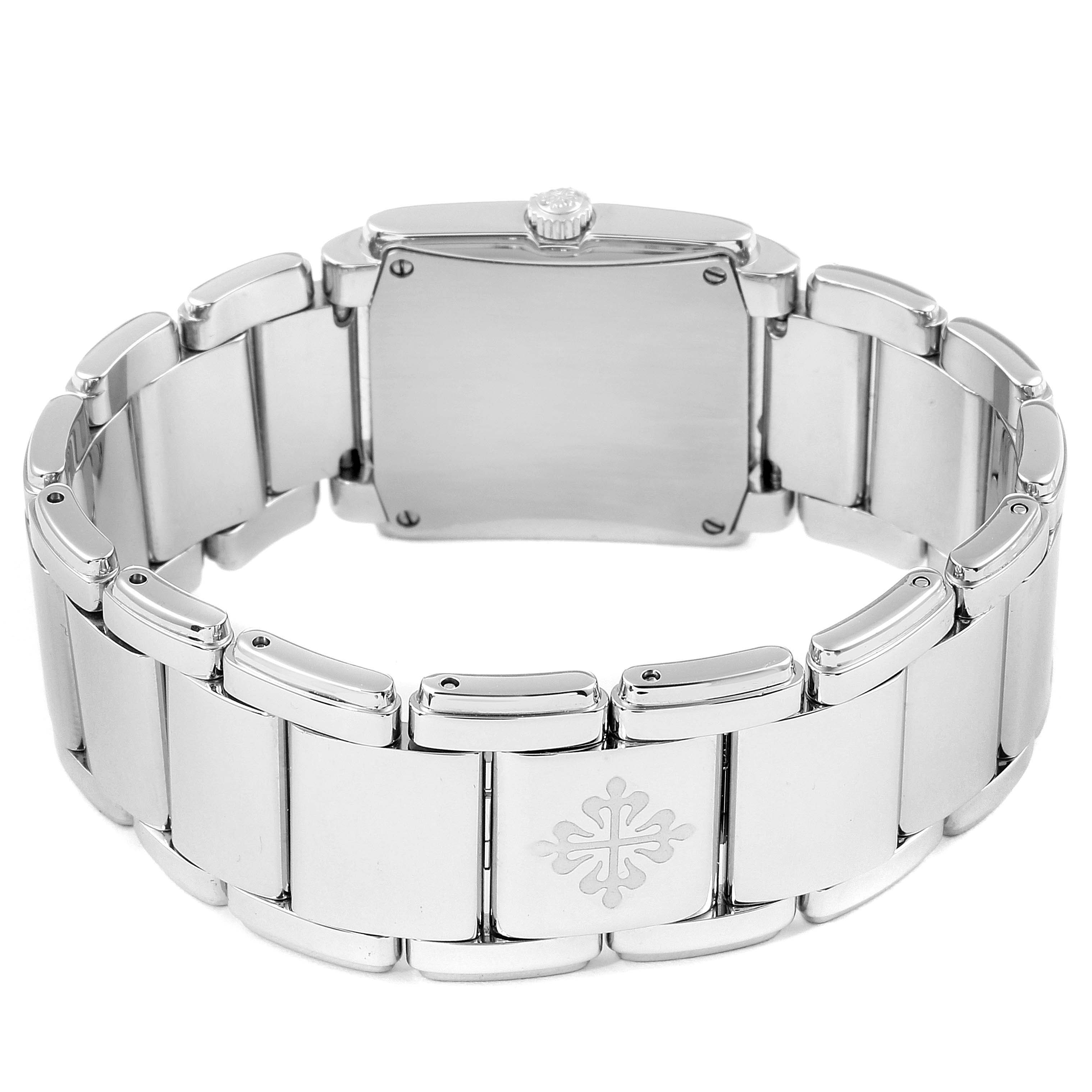 The image shows the back of a Patek Philippe Twenty-4 4910/1200A Women's Stainless Steel Blue Dial 4910/1200A Women's Stainless Steel Blue Dial watch, displaying its clasp, links, and caseback.