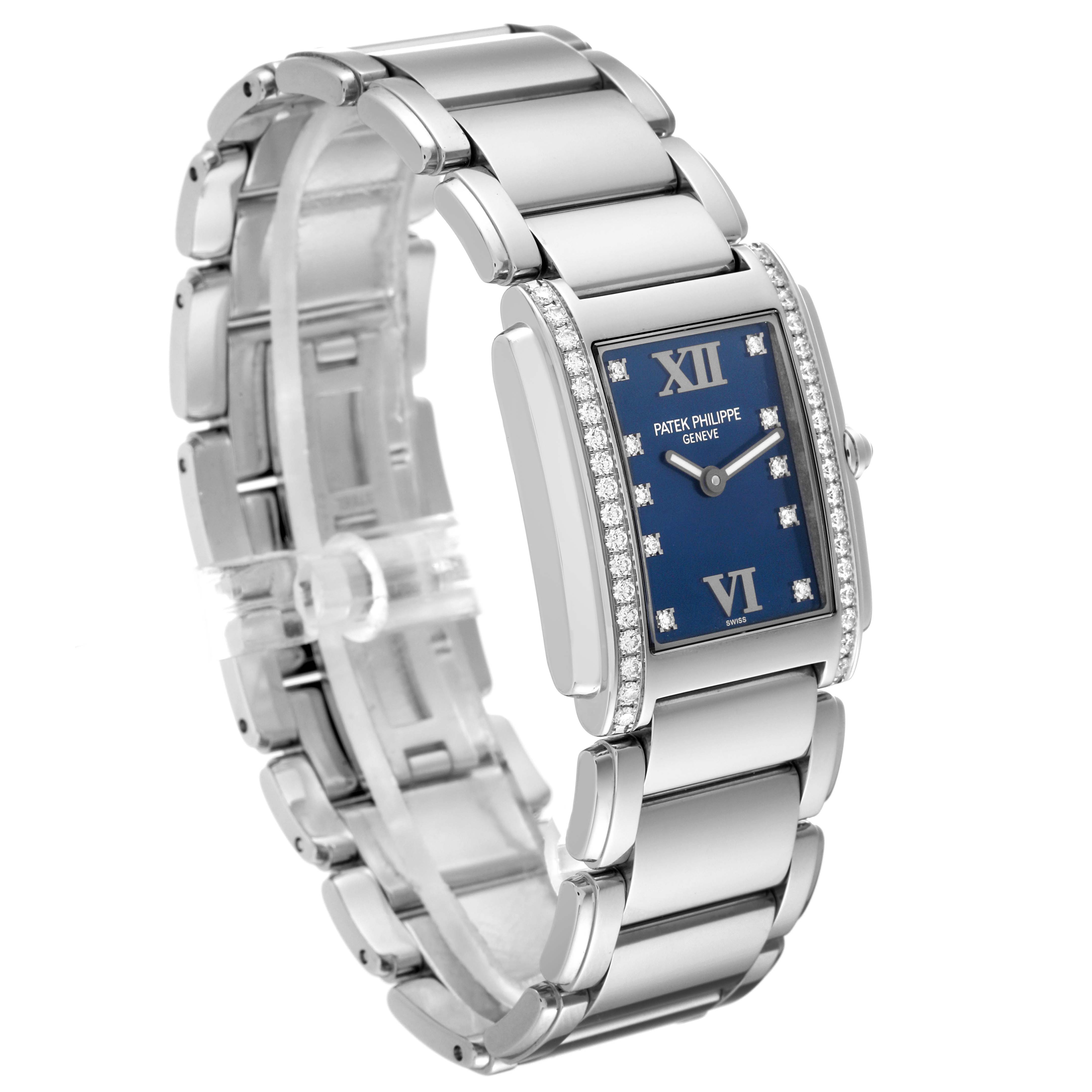The image shows a Patek Philippe Twenty-4 4910/10A-012 Women's Stainless Steel Blue Dial 4910/10A-012 Women's Stainless Steel Blue Dial watch at a three-quarter angle, highlighting its blue dial and diamond-set bezel.