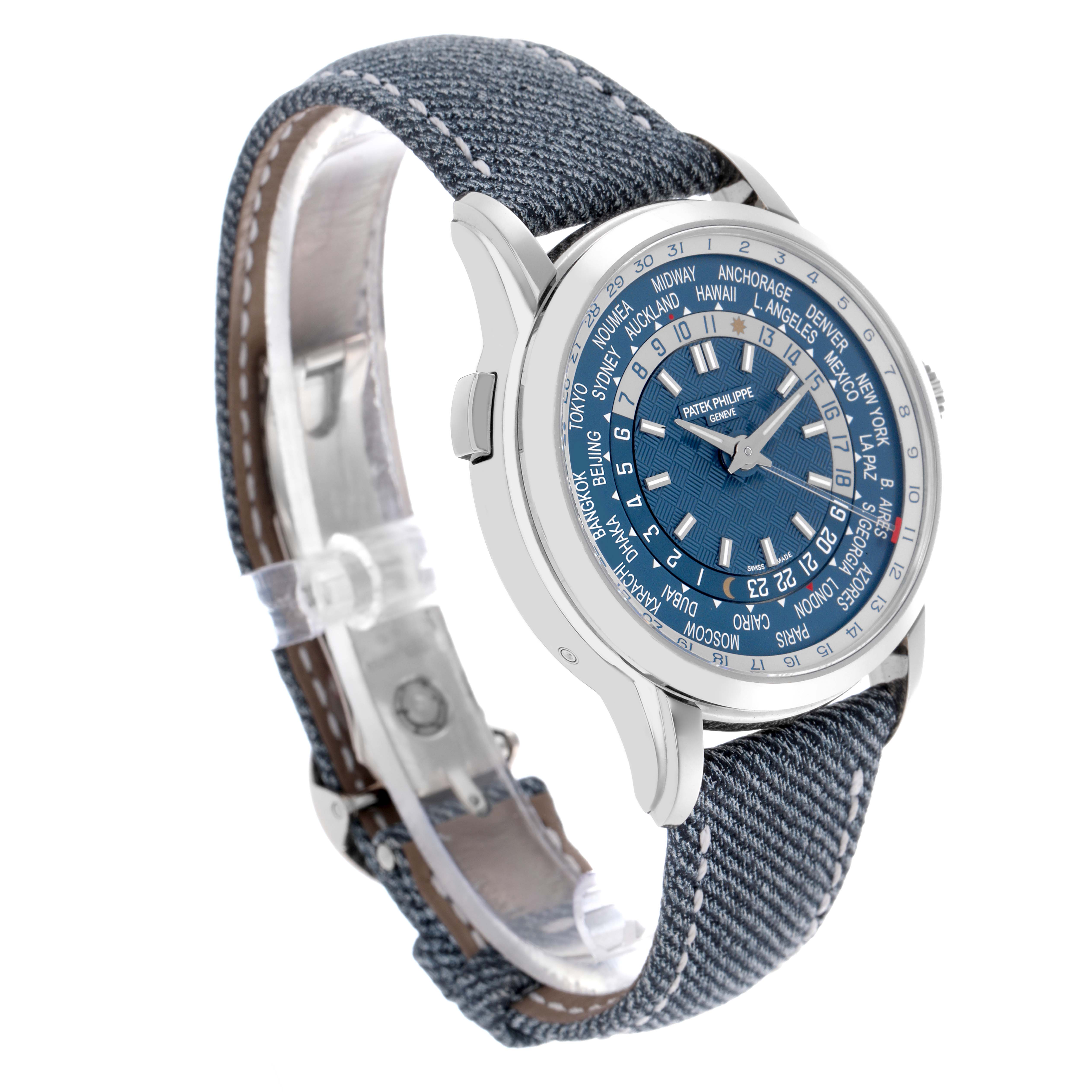 The Patek Philippe Complications 5330G-001 Men's White Gold Blue Dial 5330G-001 Men's White Gold Blue Dial watch is shown at a three-quarter angle displaying the face, side, and denim-like strap.