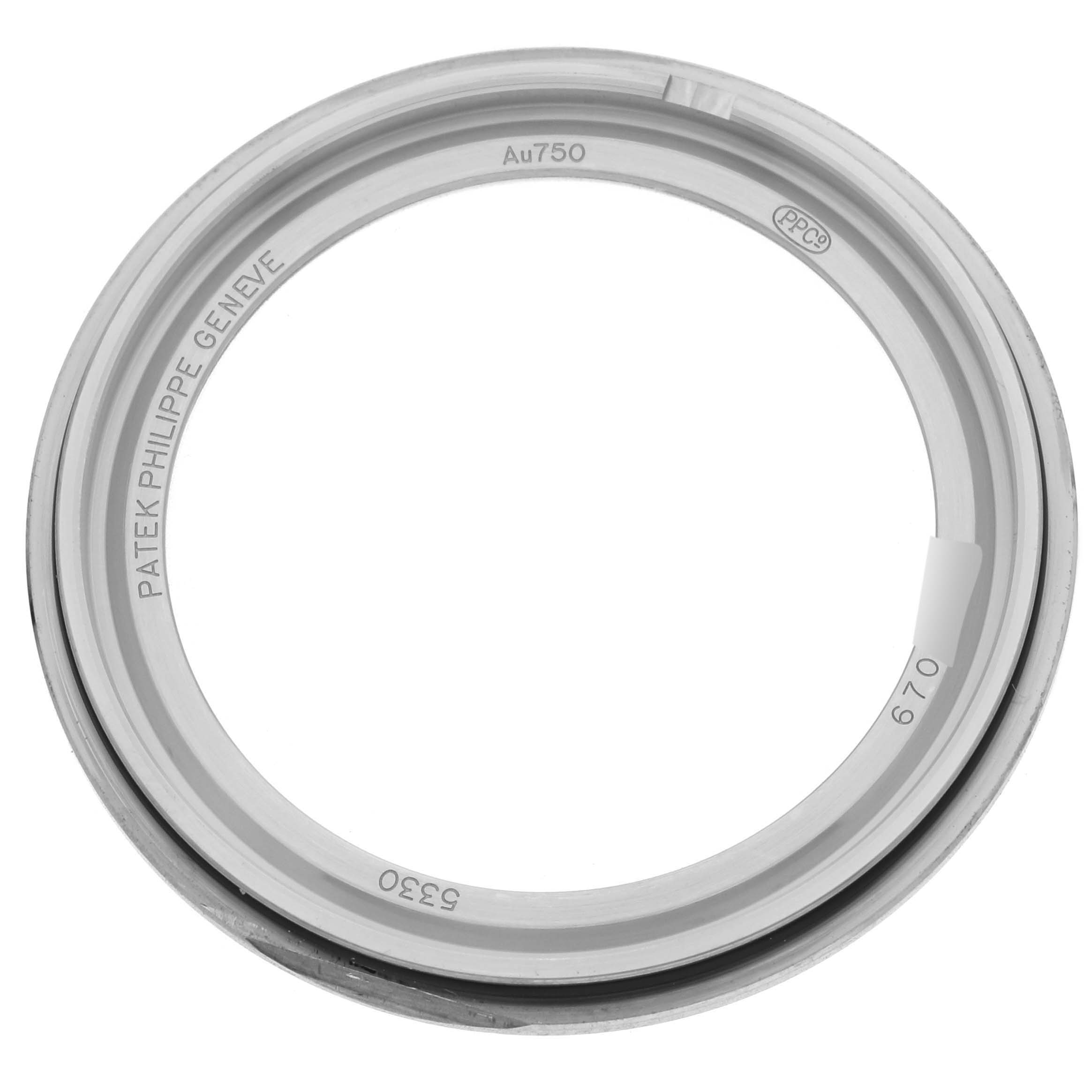 The image shows the back frame of a Patek Philippe Complications 5330G-001 Men's White Gold Blue Dial 5330G-001 Men's White Gold Blue Dial watch, featuring inscriptions and material markings.