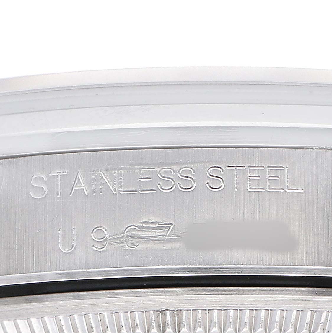 The image shows a close-up of the stainless steel case back of a Rolex Air-King 14000 Men's Stainless Steel Silver Dial watch, highlighting the material engraving.