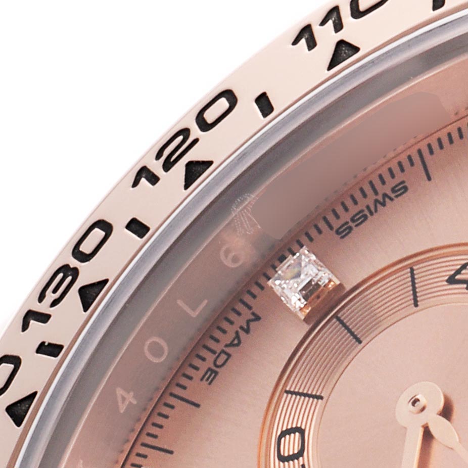 The image shows a close-up of the Rolex Daytona 116505 Men
s Rose Gold Pink Dial 116505 Men
s Rose Gold Pink Dial
s bezel and dial featuring a tachymetric scale and diamond hour marker.