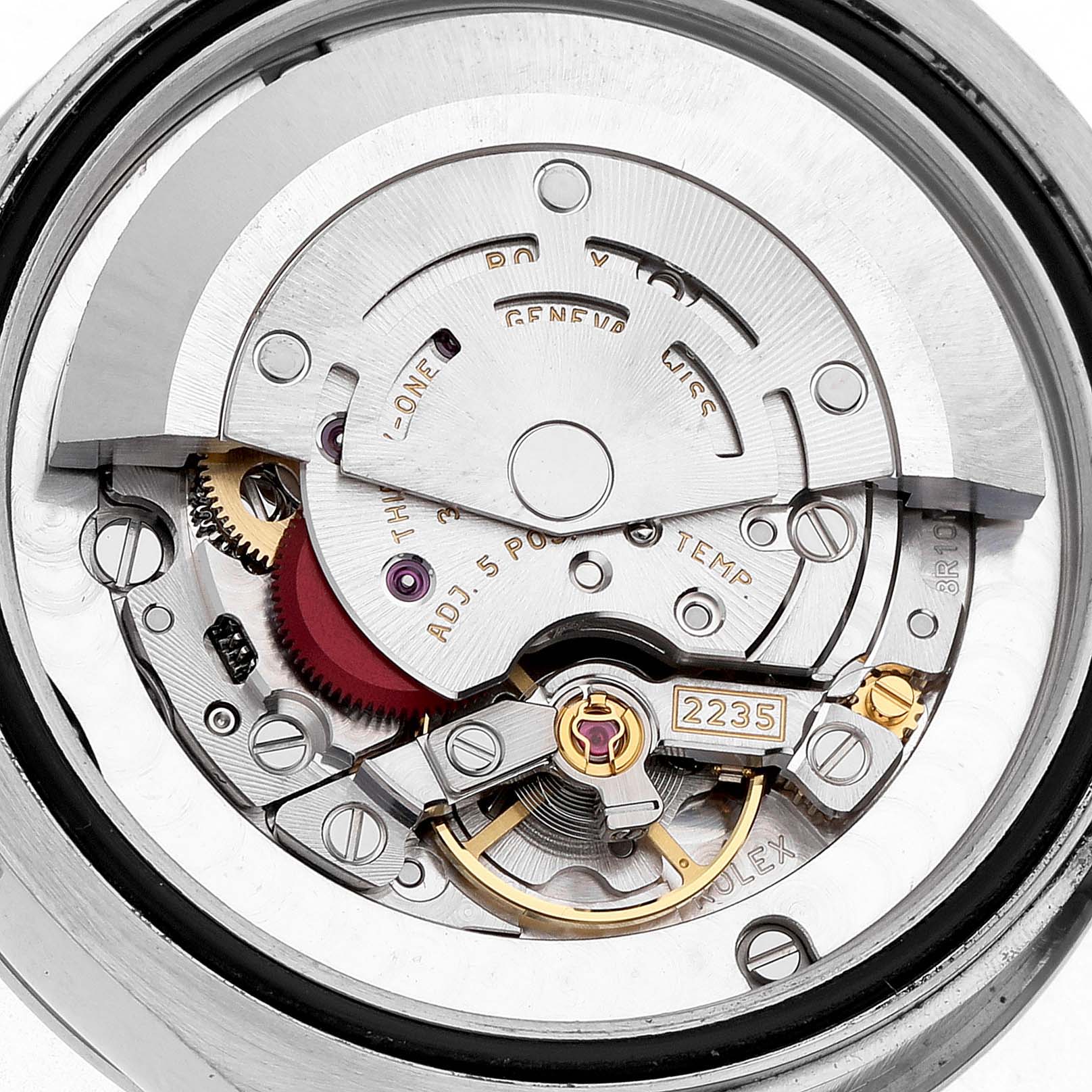 The image shows a detailed view of the Rolex Mid-Size 178344 Women's Stainless Steel Purple Dial watch movement, highlighting the rotor, gears, and balance wheel.
