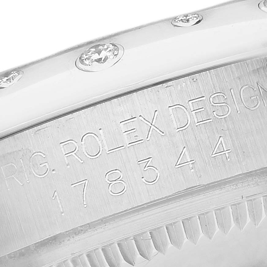 The image shows the side engraving and diamond-set bezel of a Rolex Mid-Size 178344 Women's Stainless Steel Purple Dial watch.