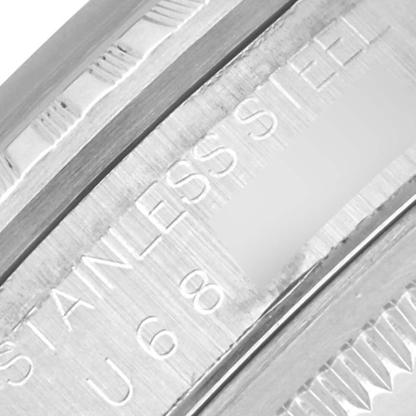 The image shows a partial view of the inner case engraving of a Rolex Datejust 16220 Men's Stainless Steel Pink Dial 16220 Men's Stainless Steel Pink Dial, focusing on the "STAINLESS STEEL" text and reference number.