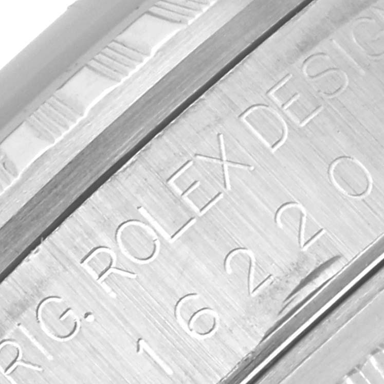 The image shows a close-up of the side of a Rolex Datejust 16220 Men's Stainless Steel Pink Dial 16220 Men's Stainless Steel Pink Dial watch, focusing on the engraved model number and brand name.