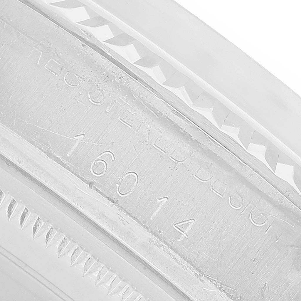 The image shows a close-up of the side engraving on the bezel of a Rolex Vintage Collection 16014 Men's Stainless Steel Silver Dial watch.