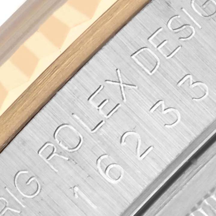 This close-up image shows the engraved side of a Rolex Datejust 16233 Men's Steel and Gold (two tone) Champagne Dial 16233 Men's Steel and Gold (two tone) Champagne Dial watch case, highlighting the model number.