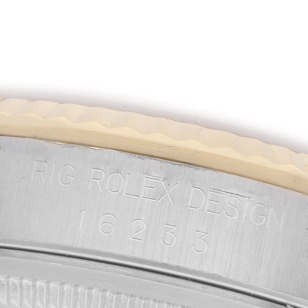 The image shows a close-up of the side of a Rolex Datejust 16233 Men's Steel and Gold (two tone) Champagne Dial 16233 Men's Steel and Gold (two tone) Champagne Dial case with engraved text and numbers.