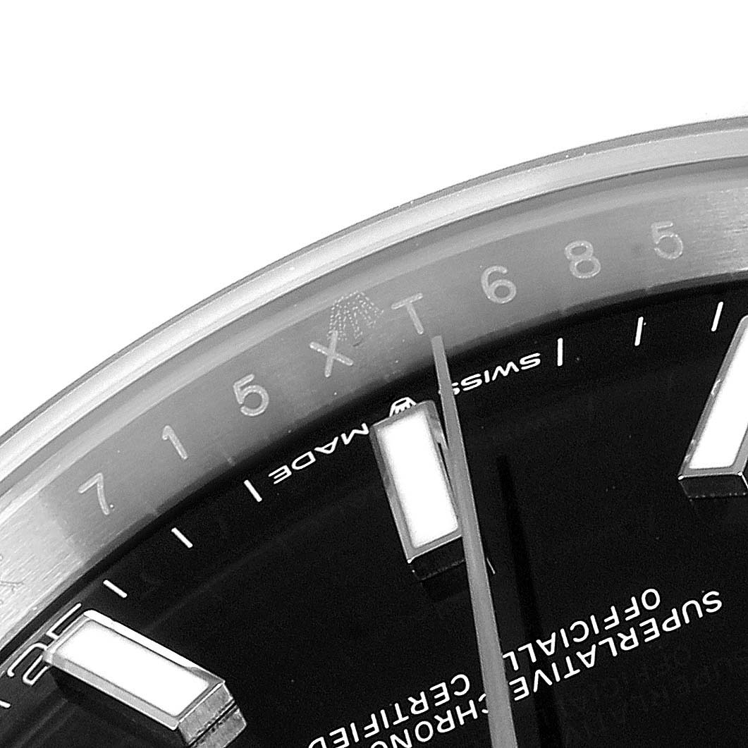 The image shows a close-up of the Rolex Datejust 41 126300 Men
s Stainless Steel Black Dial 126300 Men
s Stainless Steel Black Dial dial, highlighting the hour markers, part of the hands, and "Swiss Made" text.