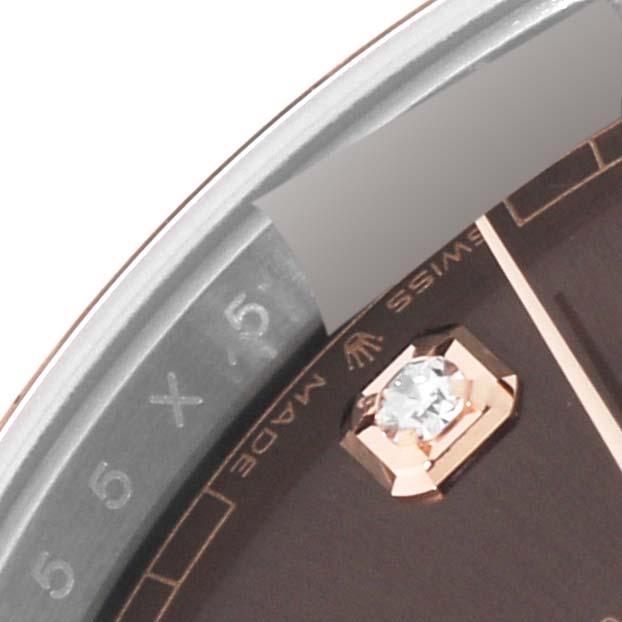 This close-up view of the Rolex Datejust 41 126301 Men's Steel and Gold (two tone) Brown Dial 126301 Men's Steel and Gold (two tone) Brown Dial shows a portion of the dial, a diamond hour marker, and part of the rehaut.