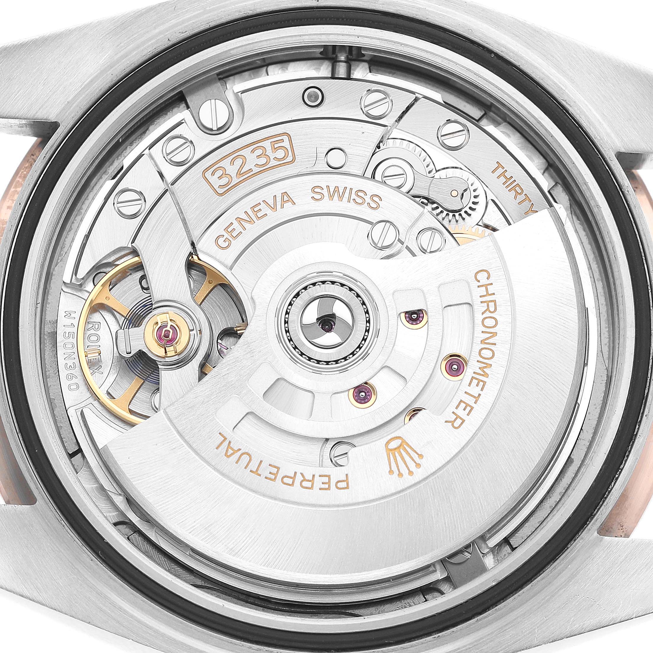 The image shows the movement mechanism of a Rolex Datejust 41 126331 Men's Steel and Gold (two tone) Grey Dial, viewed from the case back angle.