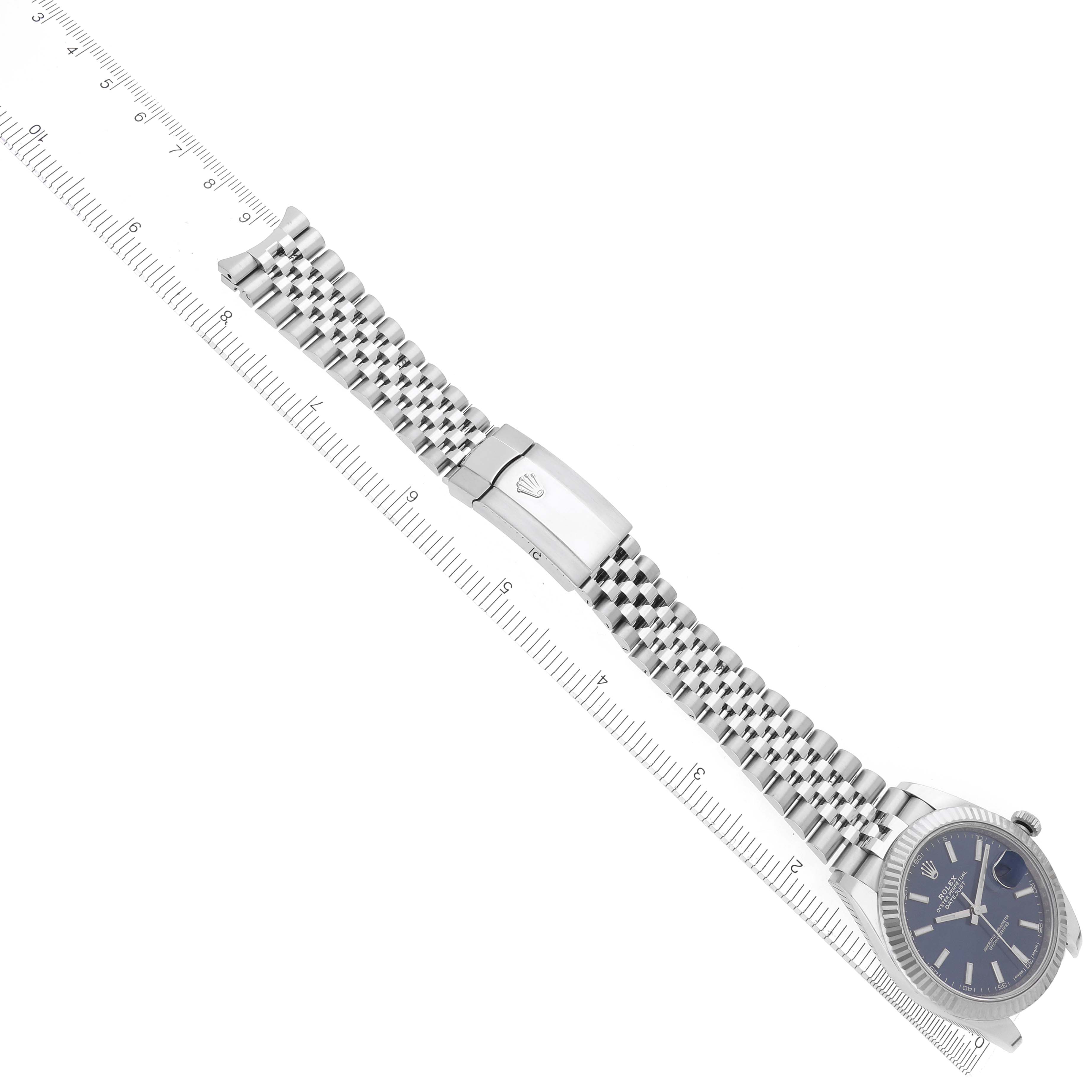 The Rolex Datejust 41 126334 Men's Stainless Steel Blue Dial 126334 Men's Stainless Steel Blue Dial is shown from an angled top view, displaying the watch face and full bracelet with a clasp and ruler for scale.