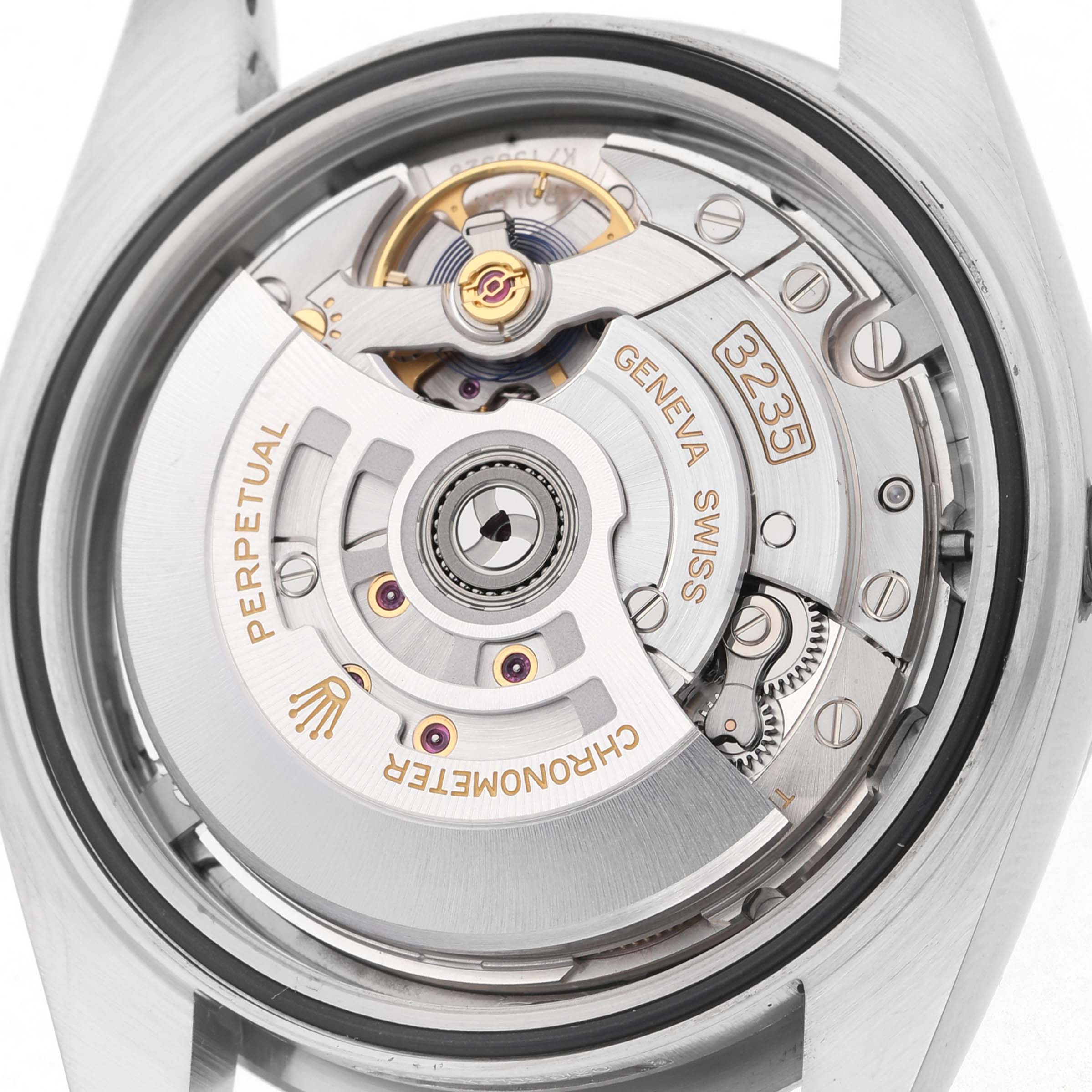 The image shows a close-up view of the Rolex Datejust 41 126334 Men's Stainless Steel Grey Dial's movement, highlighting the rotor and intricate mechanical components.