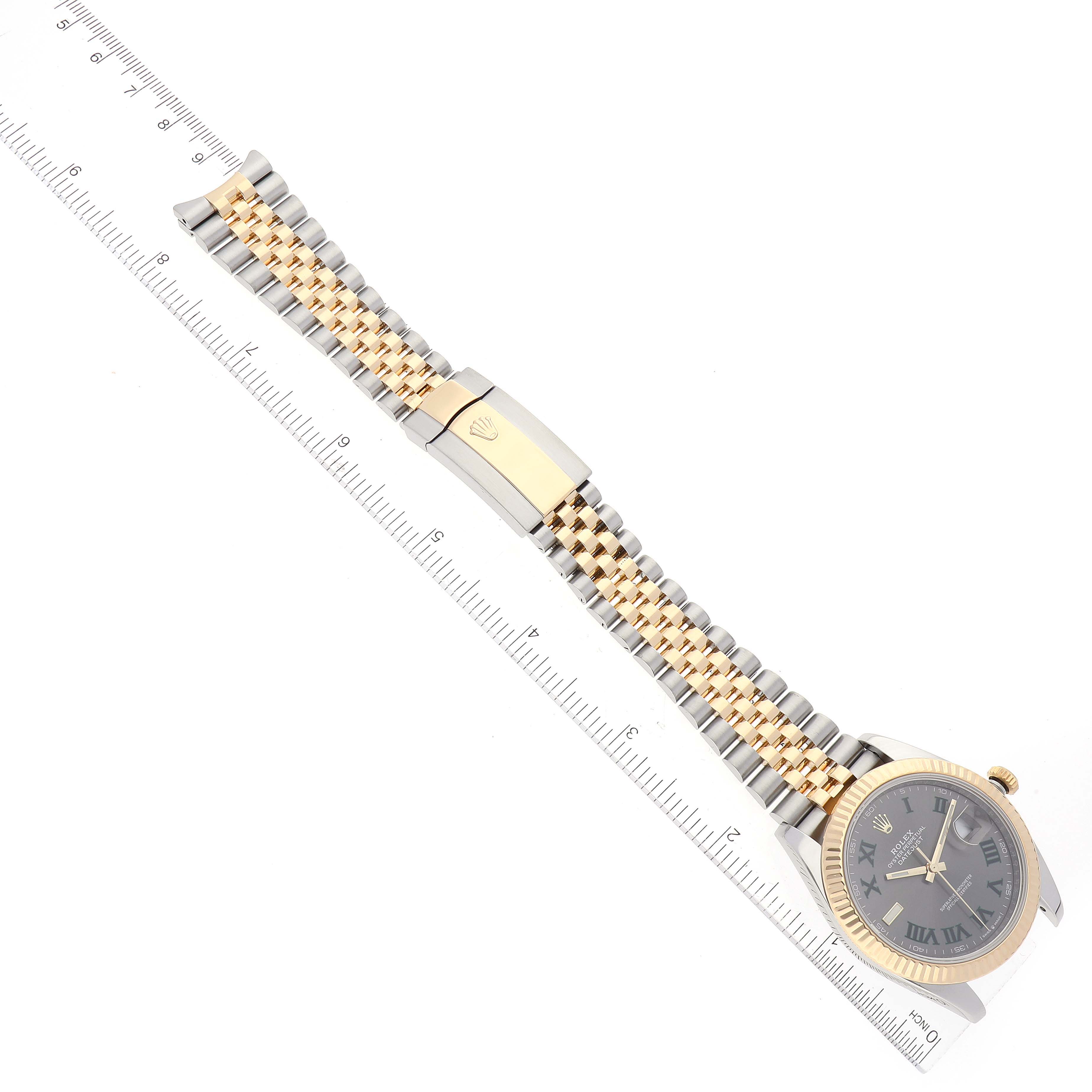 The Rolex Datejust 41 126333 Men's Steel and Gold (two tone) Grey Dial 126333 Men's Steel and Gold (two tone) Grey Dial watch is shown from a top-down angle, displaying its face, bezel, and two-tone bracelet next to a ruler.