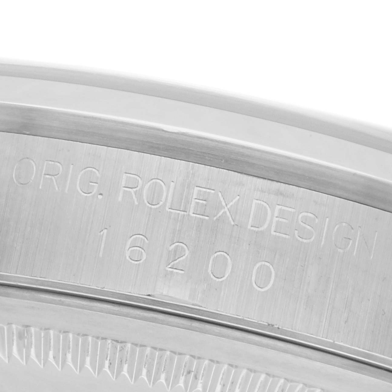 The image shows a close-up angle of the side of a Rolex Datejust 16200 Men
s Stainless Steel Blue Dial 16200 Men
s Stainless Steel Blue Dial, focusing on the engraved model number and design inscription.