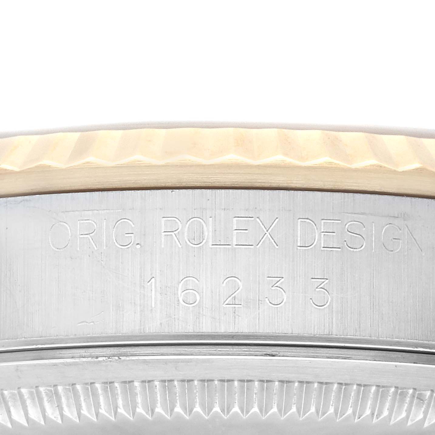 This image shows a close-up of the engraved side of a Rolex Datejust 16233 Men's Steel and Gold (two tone) Champagne Dial 16233 Men's Steel and Gold (two tone) Champagne Dial watch case, displaying the model number 16233.
