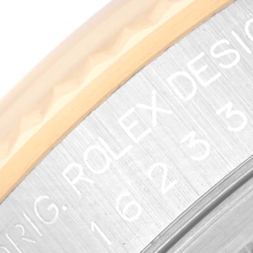 This image shows a close-up of the side edge of the case and bezel of a Rolex Datejust 16233 Men's Stainless Steel Champagne Dial 16233 Men's Stainless Steel Champagne Dial watch, with part of the engraving visible.