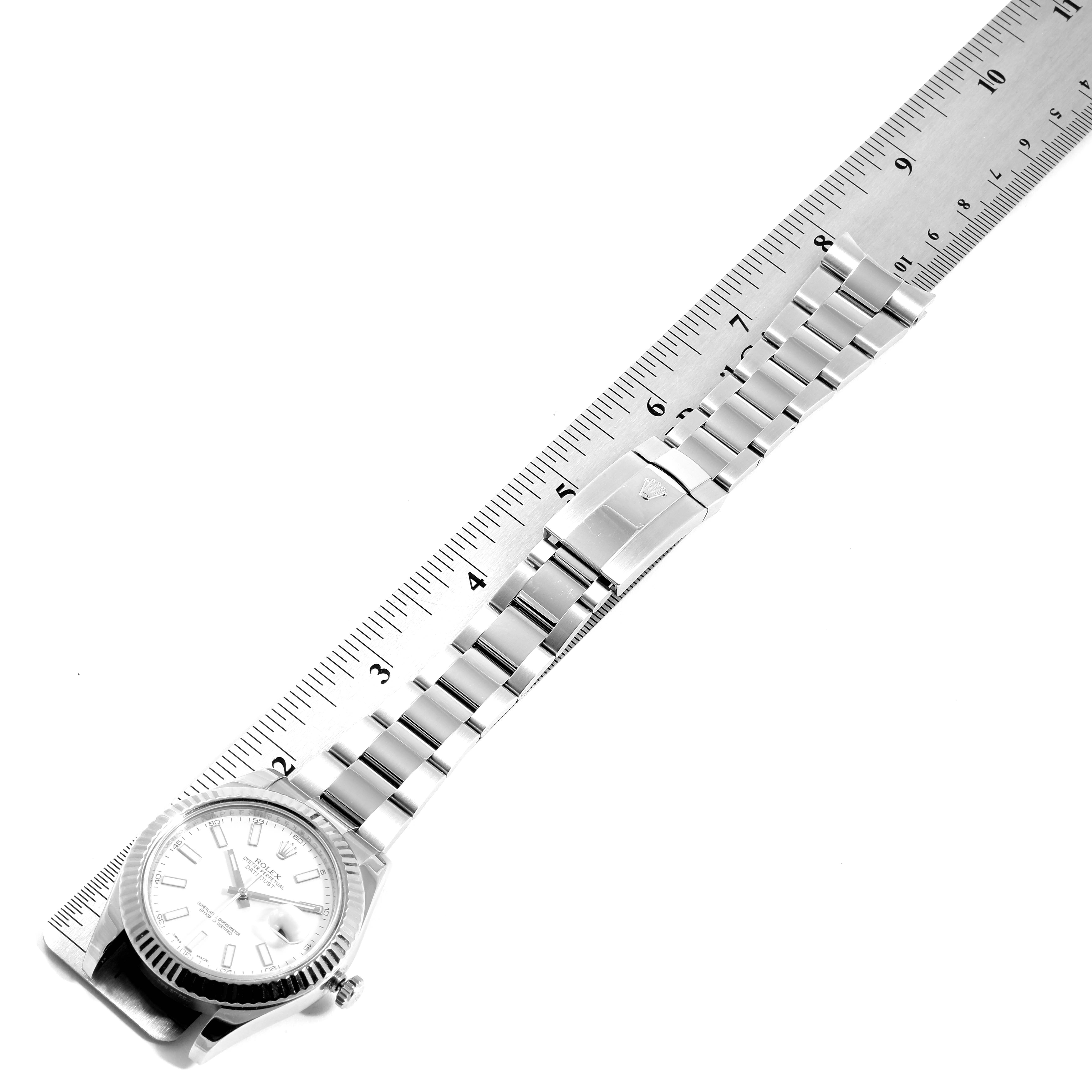 The Rolex Datejust 41 116334 Men
s Stainless Steel White Dial 116334 Men
s Stainless Steel White Dial watch is shown flat, highlighting the bracelet and clasp against a ruler for size reference.