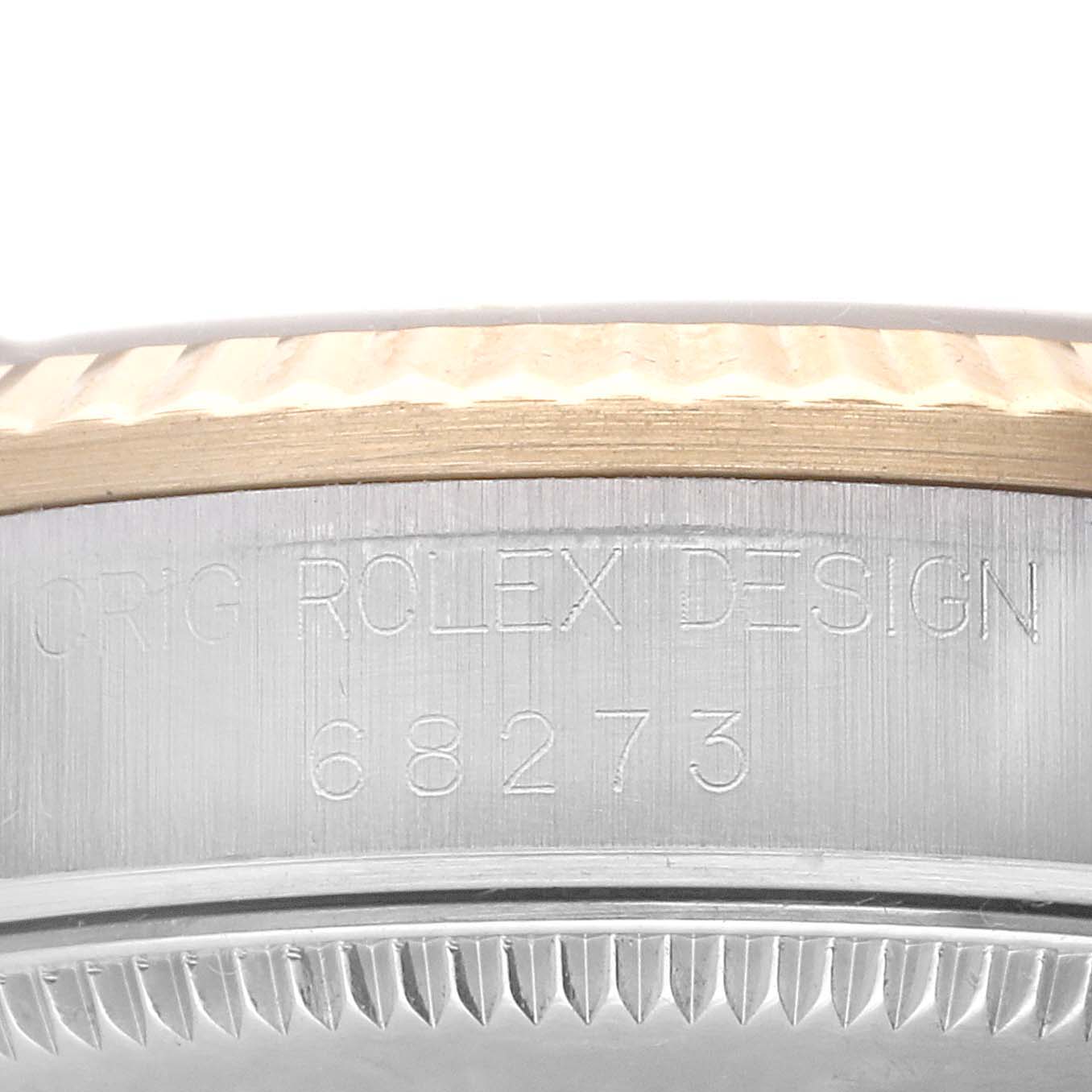 The image shows a close-up of the side of a Rolex Mid-Size 68273 Women's Steel and Gold (two tone) Black Dial 68273 Women's Steel and Gold (two tone) Black Dial model 68273, highlighting the bezel and case edges.