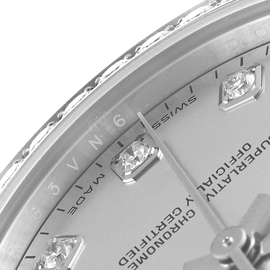 This close-up image of the Rolex Mid-Size 178384 Women
s Stainless Steel Mother of Pearl Dial 178384 Women
s Stainless Steel Mother of Pearl Dial watch shows part of the bezel, dial with diamond markers, and part of the hands.