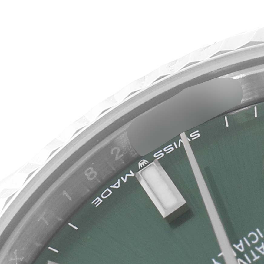 The image shows a close-up of the top-right section of the dial and bezel of a Mid-Size Rolex watch.