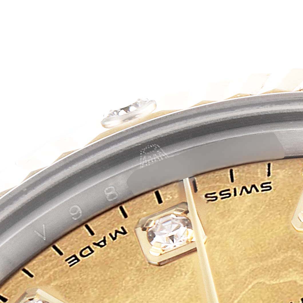 This close-up image shows the dial and inner bezel of a Rolex Mid-Size 178313 Women's Steel and Gold (two tone) Mother of Pearl Dial 178313 Women's Steel and Gold (two tone) Mother of Pearl Dial watch, including hour markers and part of the "SWISS MADE" text.