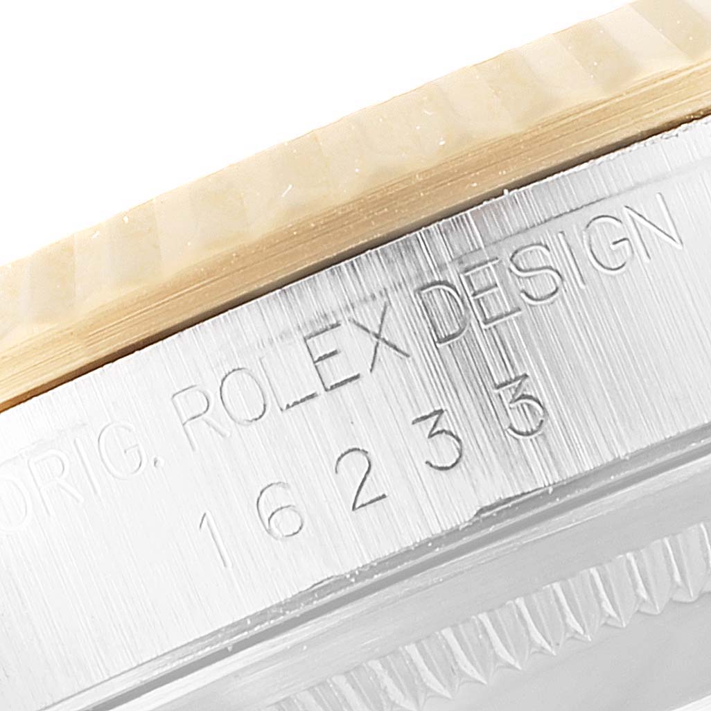 This close-up photo shows the side casing of a Rolex Datejust 16233 Men
s Steel and Gold (two tone) Grey Dial 16233 Men
s Steel and Gold (two tone) Grey Dial watch, highlighting the model number 16233 and part of the bezel.