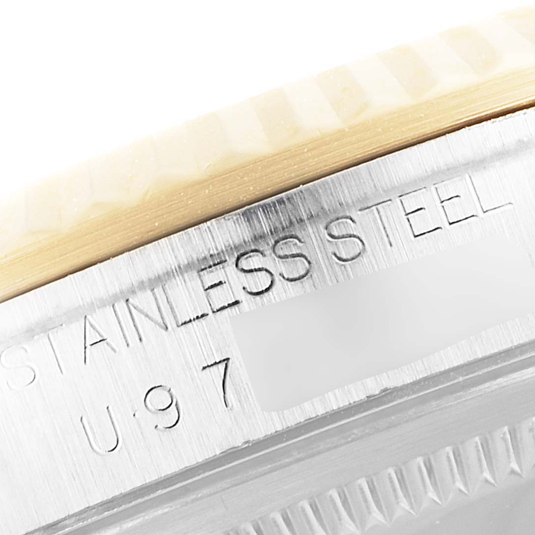 The image shows a close-up of the stainless steel case and part of the bezel of a Rolex Datejust 16233 Men
s Steel and Gold (two tone) Grey Dial 16233 Men
s Steel and Gold (two tone) Grey Dial watch.