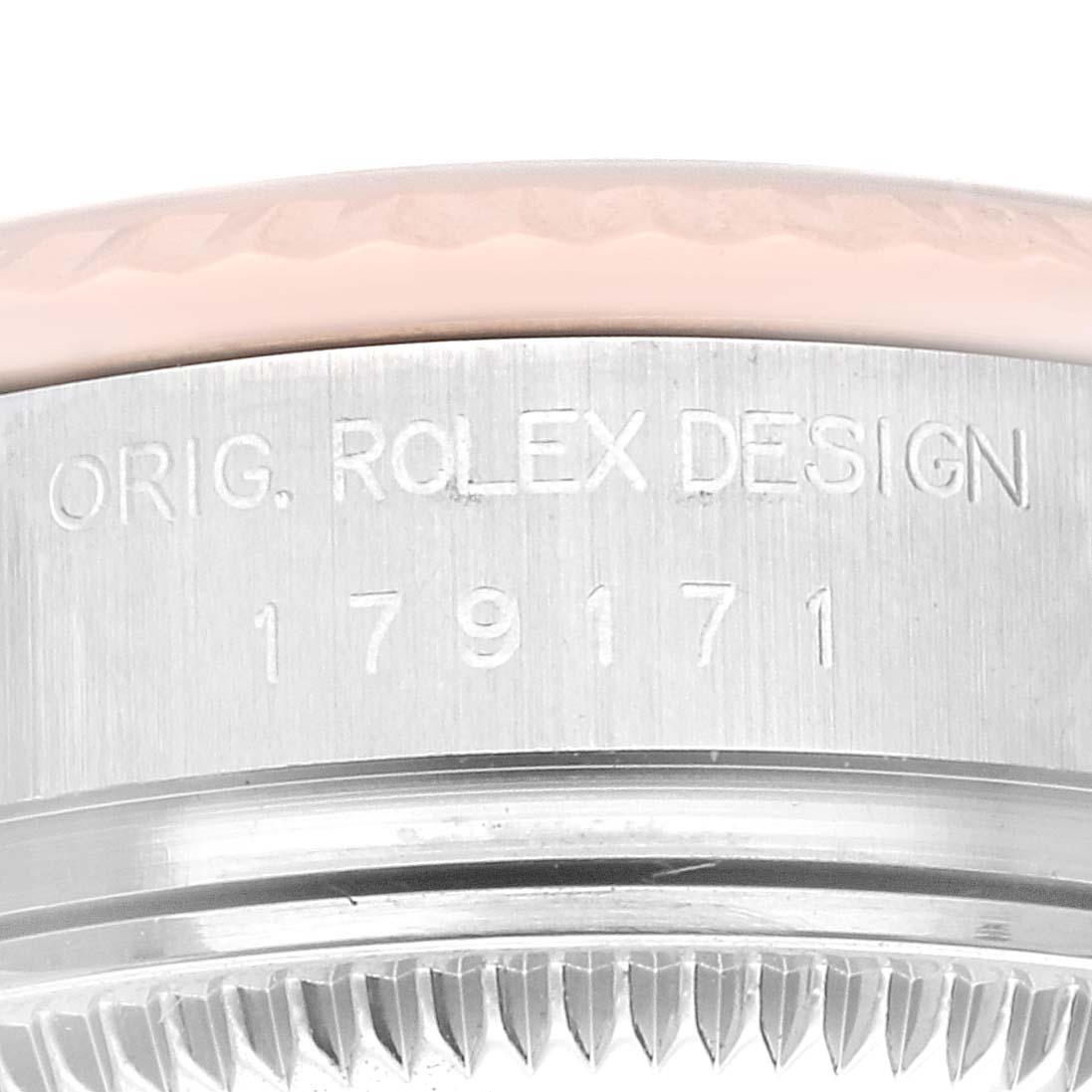 This close-up image shows the engraved serial number on the case of a Rolex Datejust 179171 Women's Steel and Gold (two tone) Pink Dial 179171 Women's Steel and Gold (two tone) Pink Dial watch.