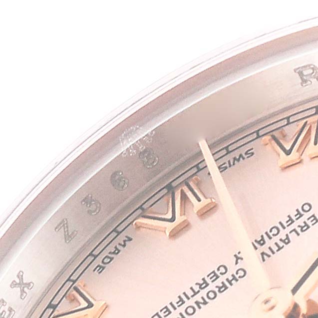 This image shows a close-up angle of the dial and Roman numeral markers of a Rolex Datejust 179171 Women's Steel and Gold (two tone) Pink Dial 179171 Women's Steel and Gold (two tone) Pink Dial watch.