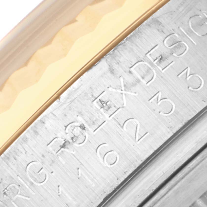 The image shows a close-up of the Rolex Datejust 116233 Men's Steel and Gold (two tone) Champagne Dial 116233 Men's Steel and Gold (two tone) Champagne Dial model, focusing on the engraved inner bezel.