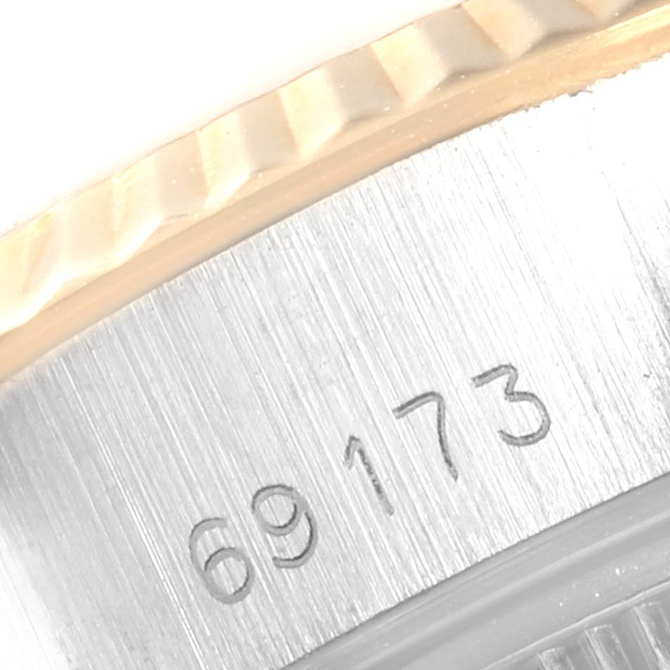 This image shows a close-up of the serial number and fluted bezel on a Rolex Datejust 69173 Women's Stainless Steel Champagne Dial 69173 Women's Stainless Steel Champagne Dial watch.