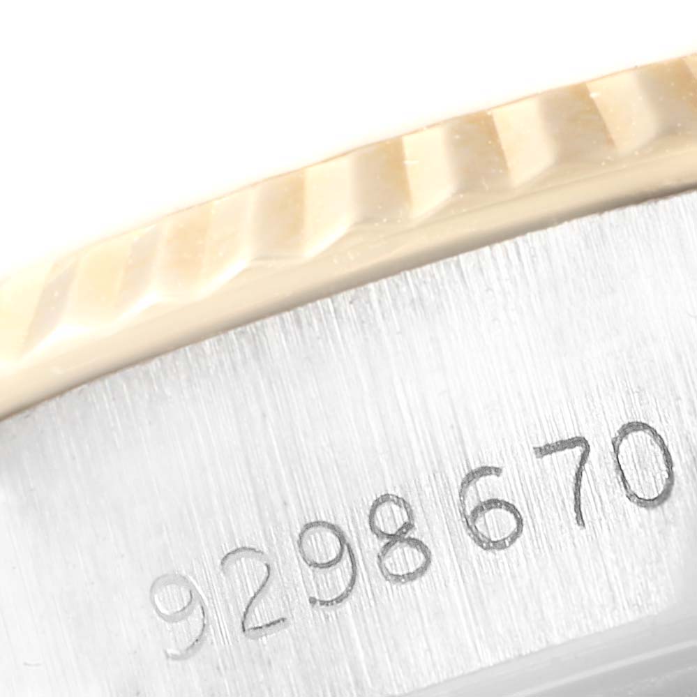 This image shows a close-up of the serial number and fluted bezel of a Rolex Datejust 69173 Women's Stainless Steel Champagne Dial 69173 Women's Stainless Steel Champagne Dial watch.