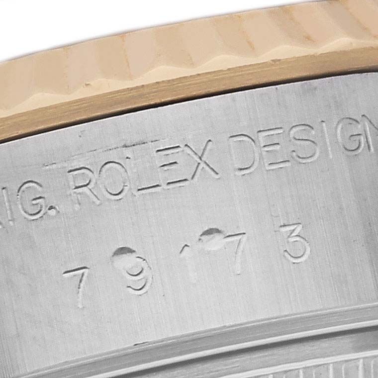 The image shows a close-up of the engraved side of a Rolex Datejust 79173 Women's Steel and Gold (two tone) Green Dial 79173 Women's Steel and Gold (two tone) Green Dial watch, highlighting the model number and "ROLEX DESIGN" text.