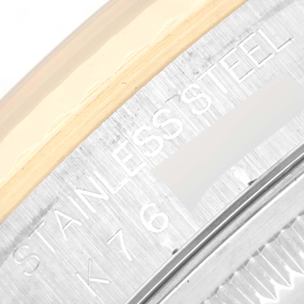 This image shows a close-up of the engraved stainless steel part on the side of a Rolex Datejust 16233 Men's Steel and Gold (two tone) Mother of Pearl Dial 16233 Men's Steel and Gold (two tone) Mother of Pearl Dial watch.