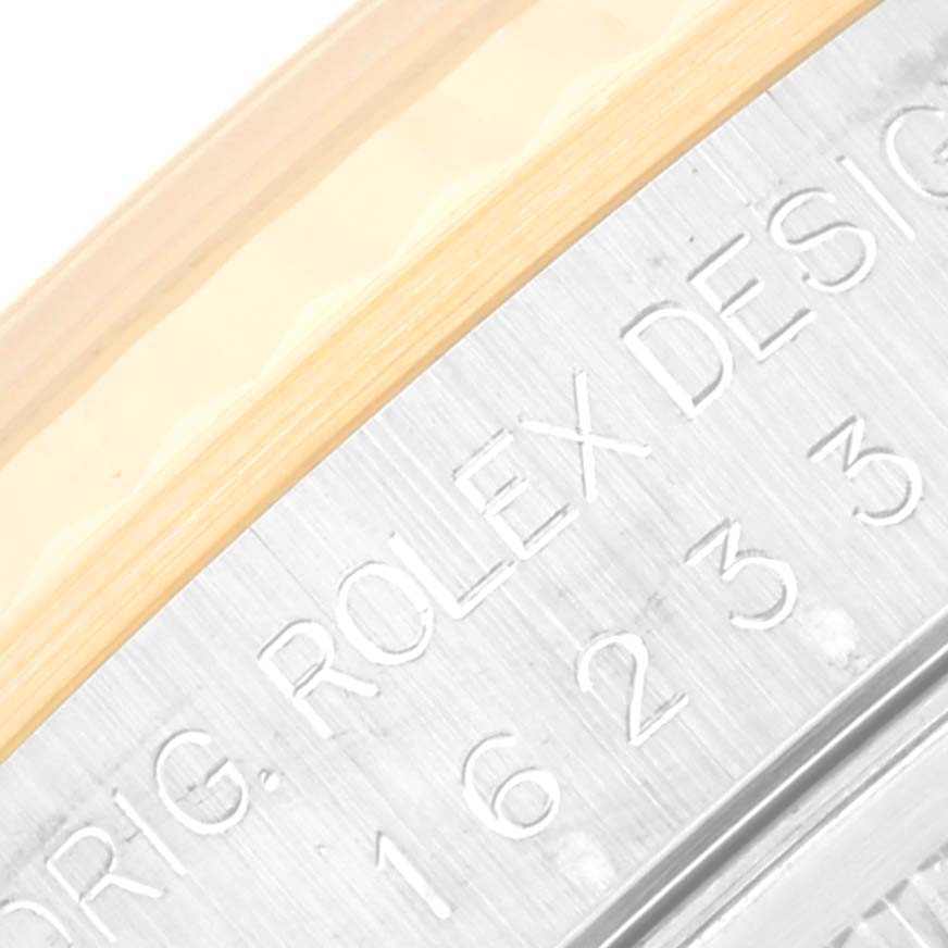 This image shows a close-up of the side of a Rolex Datejust 16233 Men's Steel and Gold (two tone) Mother of Pearl Dial 16233 Men's Steel and Gold (two tone) Mother of Pearl Dial watch case, highlighting the engraved text and part of the bezel.
