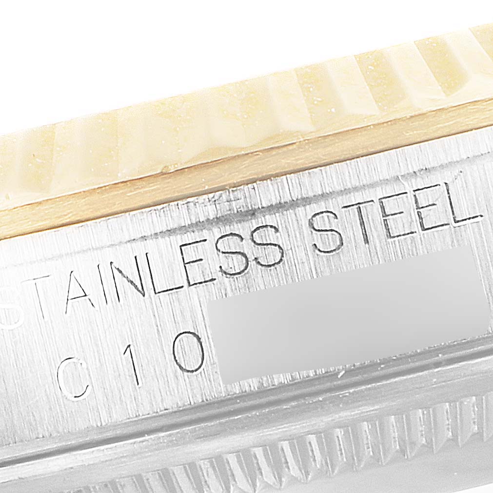 The image shows a close-up of the Rolex Datejust 16233 Men
s Steel and Gold (two tone) Beige Dial 16233 Men
s Steel and Gold (two tone) Beige Dial model
s fluted bezel and case with the "STAINLESS STEEL" engraving visible.