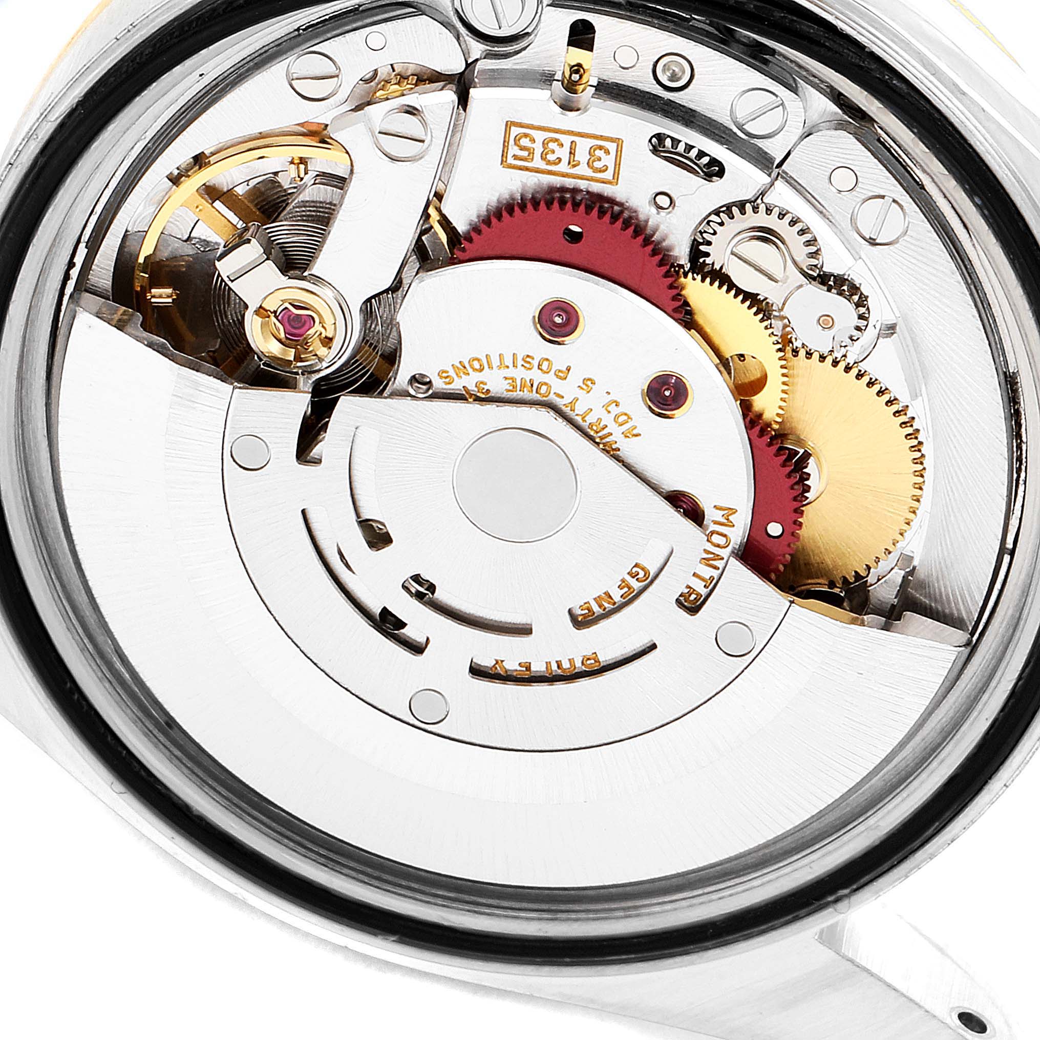 This is a close-up view of the movement mechanism of a Rolex Datejust 16233 Men
s Steel and Gold (two tone) Beige Dial 16233 Men
s Steel and Gold (two tone) Beige Dial watch, showing gears and intricate components.