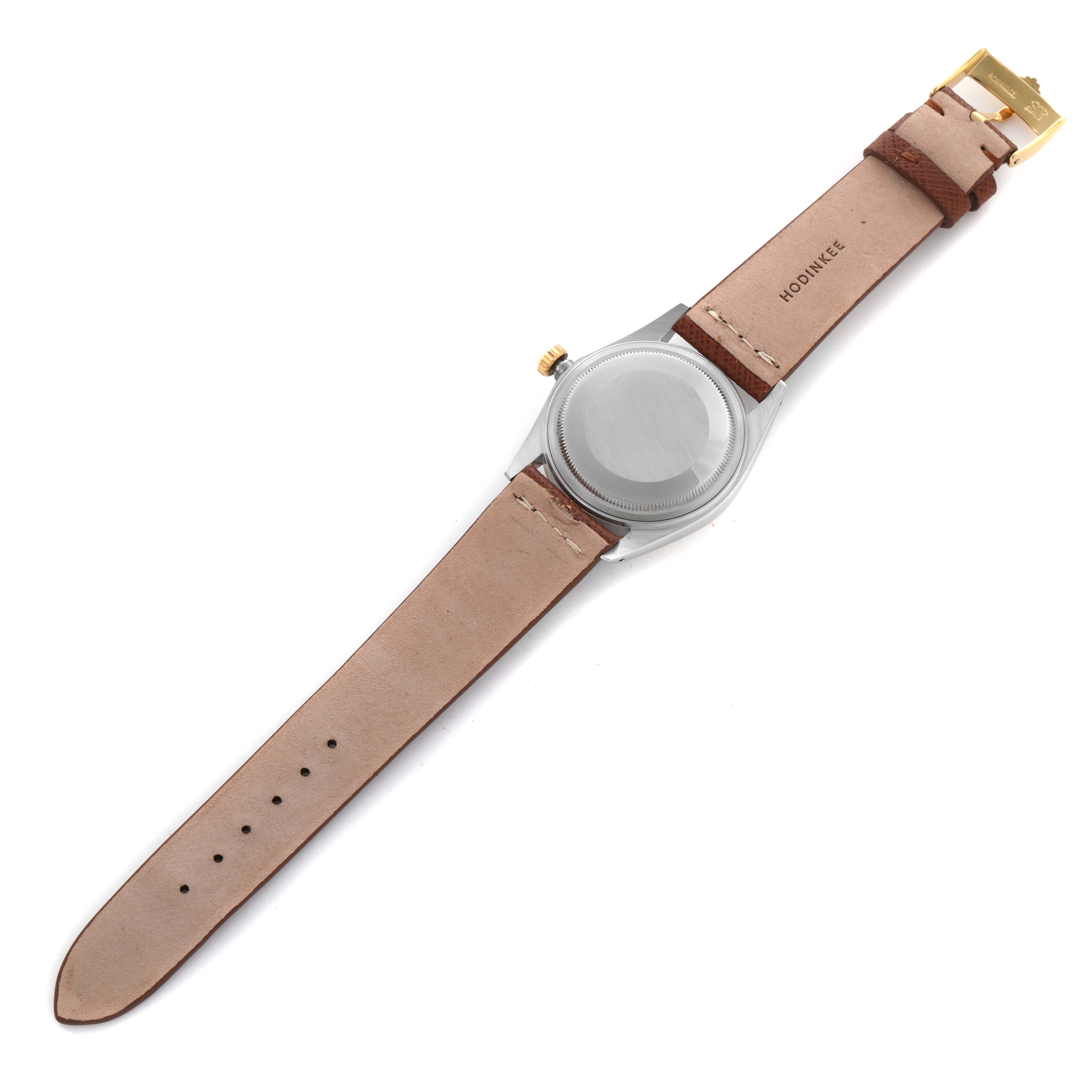 The Rolex Vintage Collection 16013 Men's Steel and Gold (two tone) Champagne Dial 16013 Men's Steel and Gold (two tone) Champagne Dial watch is shown from the back, highlighting the case back and leather strap with a gold buckle.