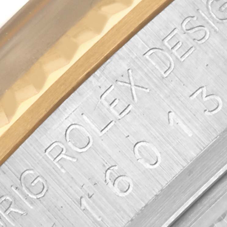 This close-up image shows the engraved side of the bezel and case of a Rolex Vintage Collection 16013 Men's Steel and Gold (two tone) Champagne Dial 16013 Men's Steel and Gold (two tone) Champagne Dial watch.