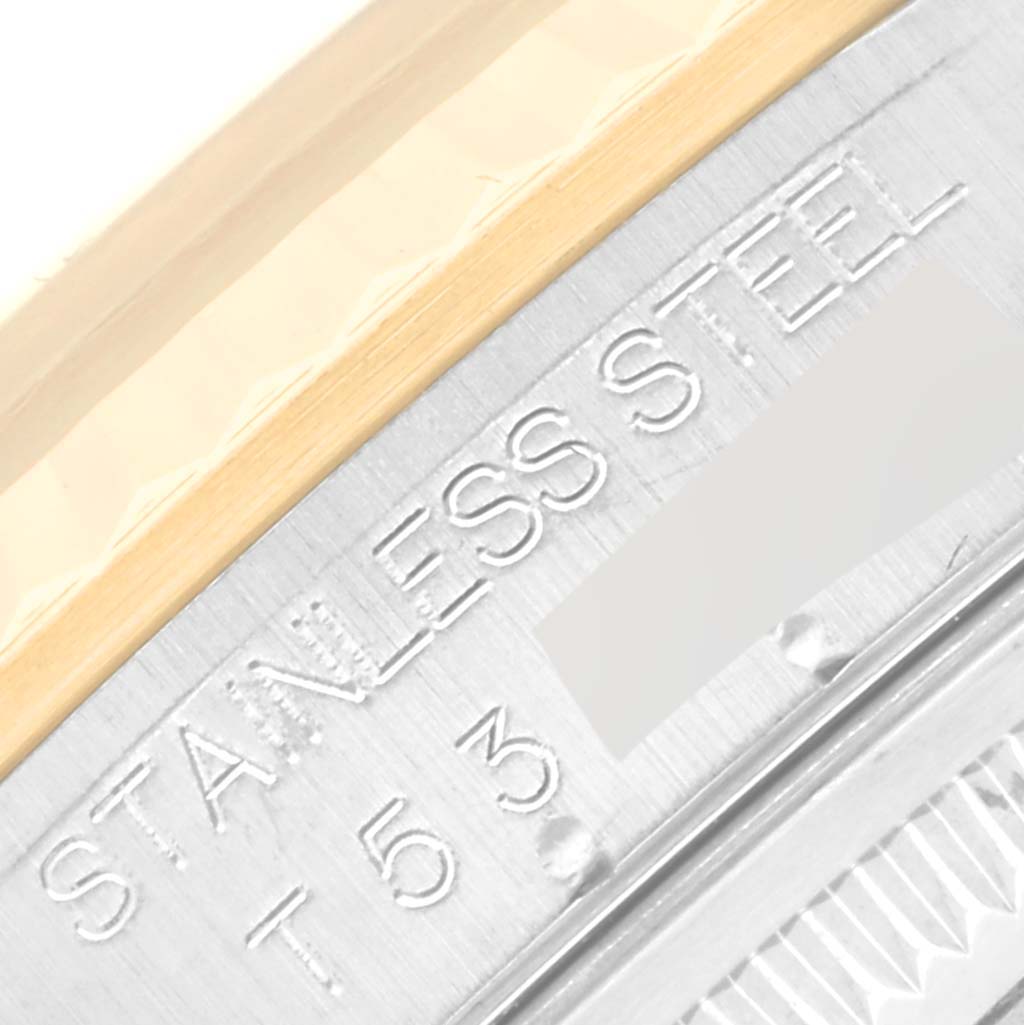 This close-up shows the engraving on the side of the bezel of a Rolex Datejust 16233 Men's Steel and Gold (two tone) White Dial 16233 Men's Steel and Gold (two tone) White Dial model, focusing on the stainless steel part.