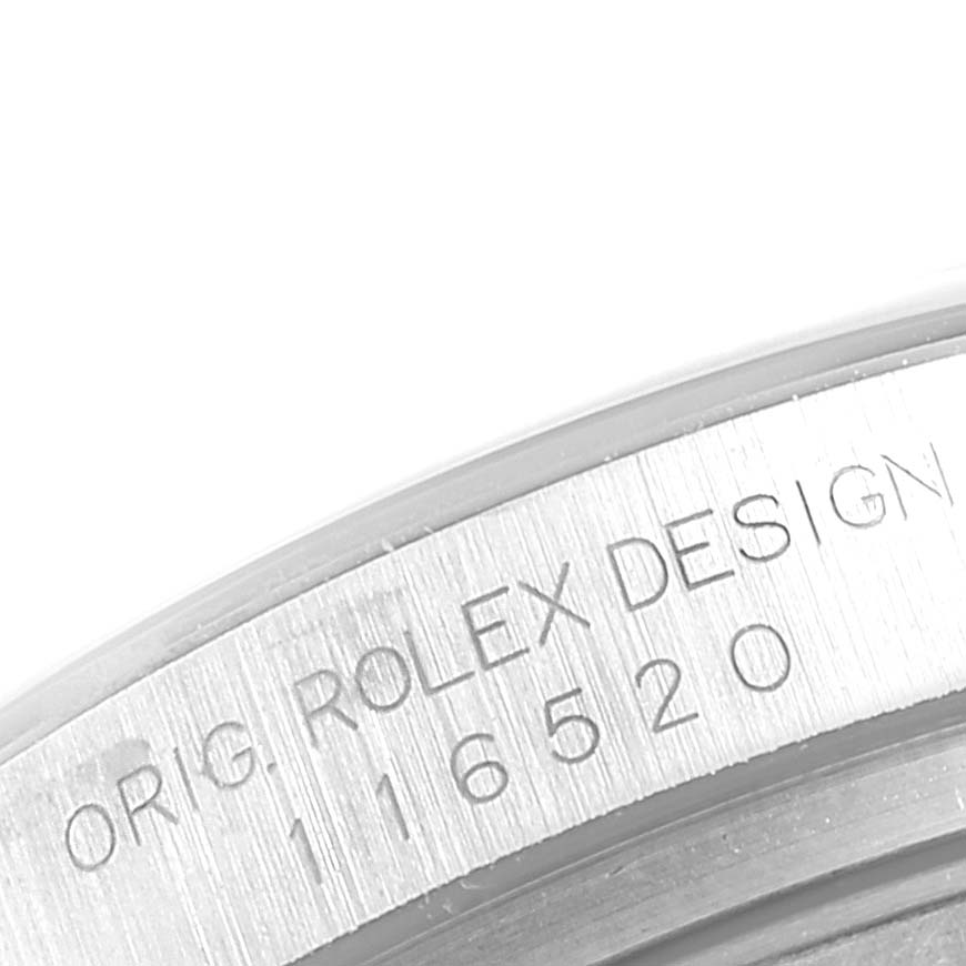 The image shows a close-up of the engraved serial number on the bezel of a Rolex Daytona 116520 Men's Stainless Steel Black Dial 116520 Men's Stainless Steel Black Dial watch.