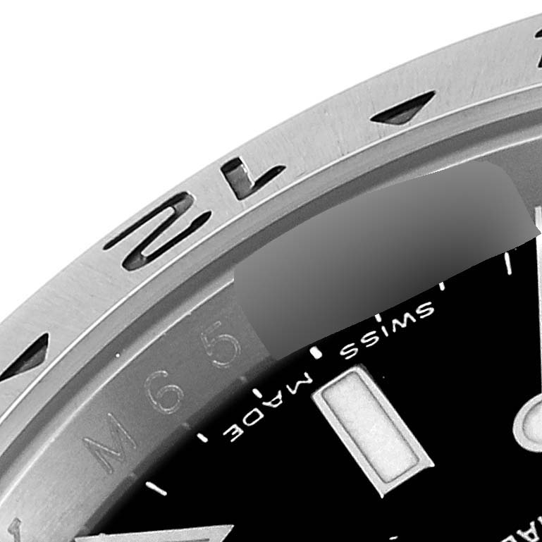 This image shows a close-up of the bezel, part of the dial, and markings of a Rolex Explorer 16570 Men
s Stainless Steel Black Dial 16570 Men
s Stainless Steel Black Dial watch.
