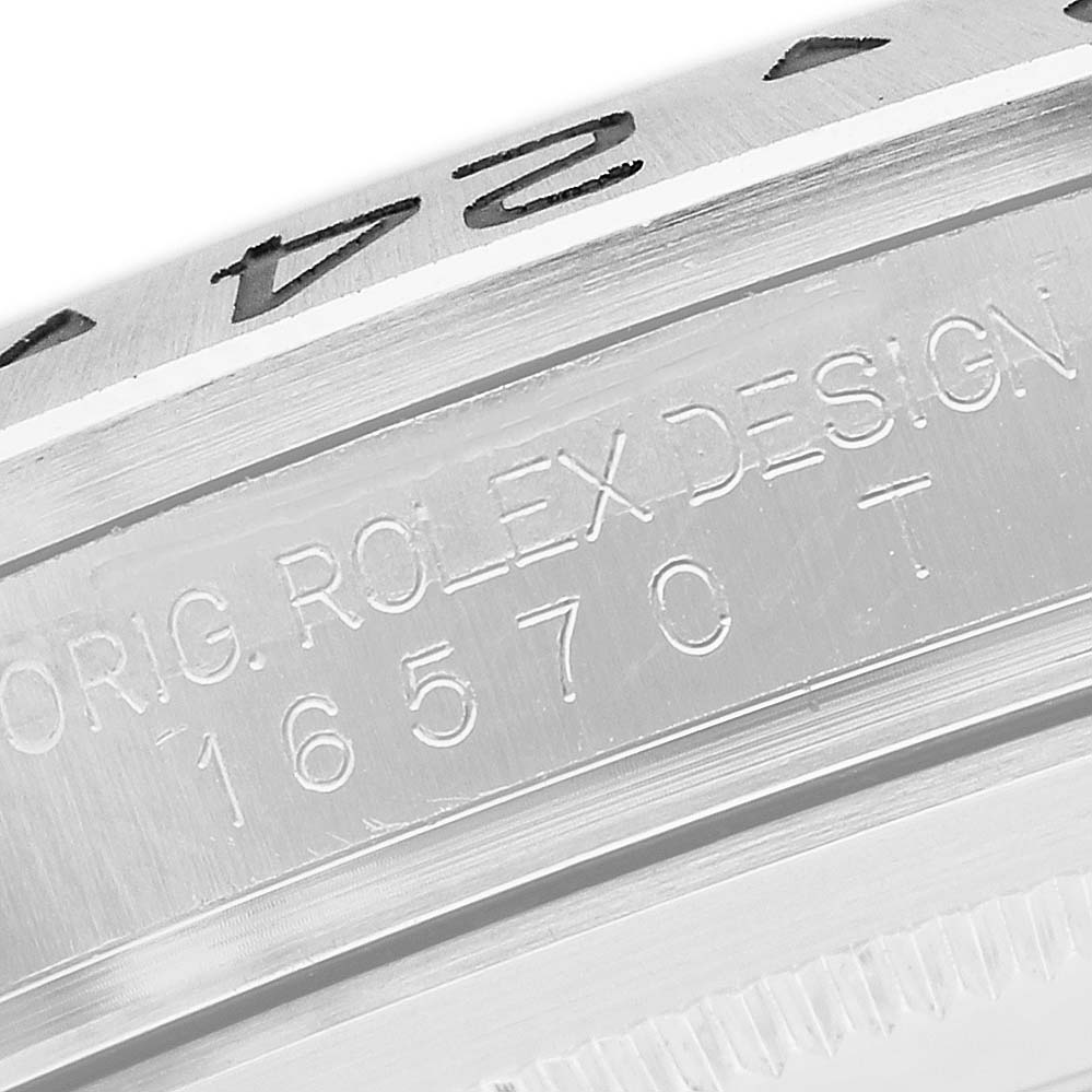 The image shows a close-up of the side of a Rolex Explorer 16570 Men's Stainless Steel Black Dial, highlighting the bezel and engraved model details.